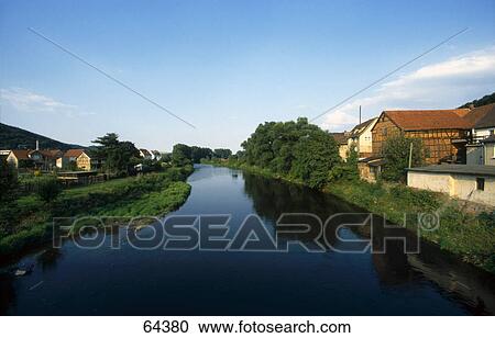 River flowing through town, Saale River, Thuringia, Germany View Large Photo Image Stock Image - River flowing through town, Saale River, Thuringia, Germany . Fotosearch