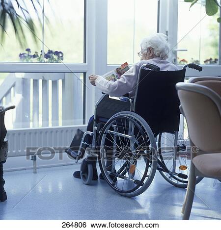 Stock Photograph - Senior woman sitting in wheelchair . Fotosearch