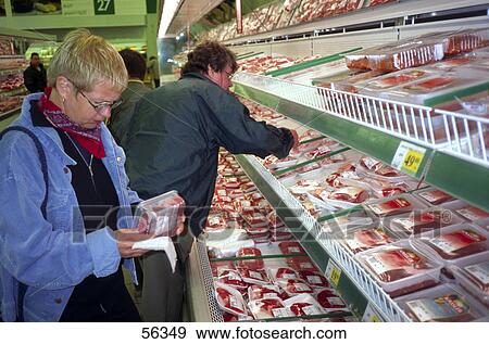 Stock Photo - Side view of people buying meats in a supermarket . Fotosearch
