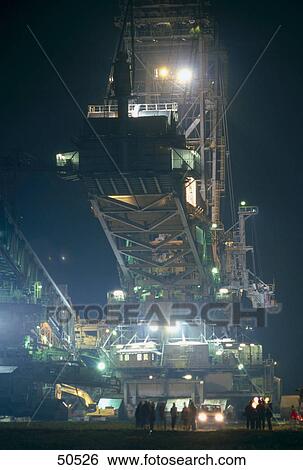 Stock Photograph - Silhouette of people working at opencast mine, Garzweiler, Germany . Fotosearch