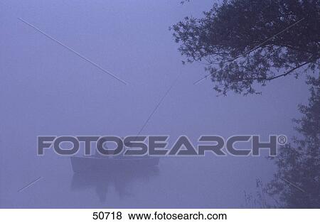 Stock Photo - Silhouette of two fishermen on boat in lake, Bavaria, Germany . Fotosearch