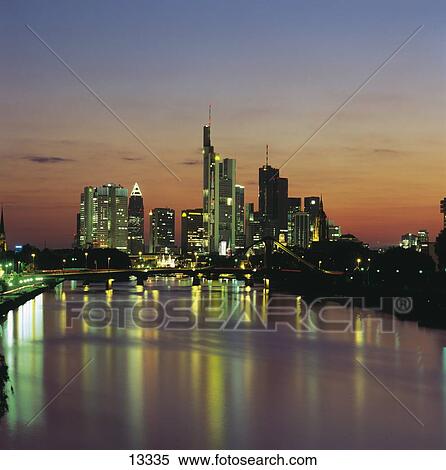 Stock Photography - Skyscrapers in city at dusk, Main River, Frankfurt, Germany . Fotosearch
