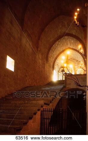 Stairs near gate leading to lit up interiors of building View Large Photo Image Stock Photograph - Stairs near gate leading to lit up interiors of building . Fotosearch