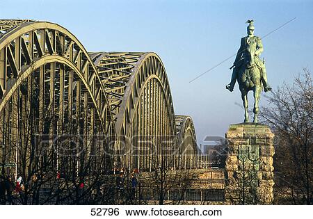 Statue in front of bride, Hohenzollern Bridge, Cologne, North Rhine-Westphalia, Germany View Large Photo Image Stock Photograph - Statue in front of bride, Hohenzollern Bridge, Cologne, North Rhine-Westphalia, Germany . Fotosearch