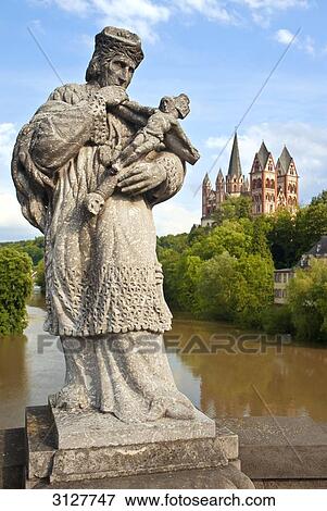 Statue on a bridge, Limburg cathedral in the background, Limburg an der Lahn, Germany View Large Photo Image Stock Photo - Statue on a bridge, Limburg cathedral in the background, Limburg an der Lahn, Germany . Fotosearch
