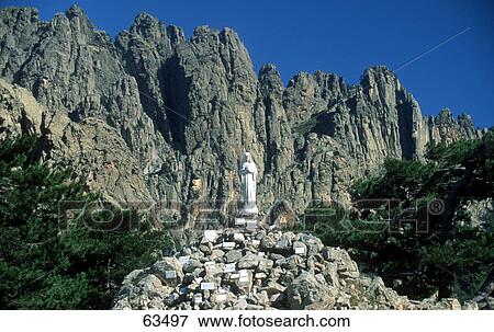 Statue on top of pile of rocks, Bavella, Corsica, France View Large Photo Image Stock Photo - Statue on top of pile of rocks, Bavella, Corsica, France . Fotosearch