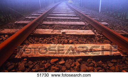 Stock Image - Sunlight on railroad track . Fotosearch