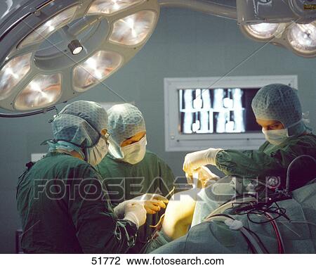 Surgeons operating on patient View Large Photo Image Stock Image - Surgeons operating on patient . Fotosearch