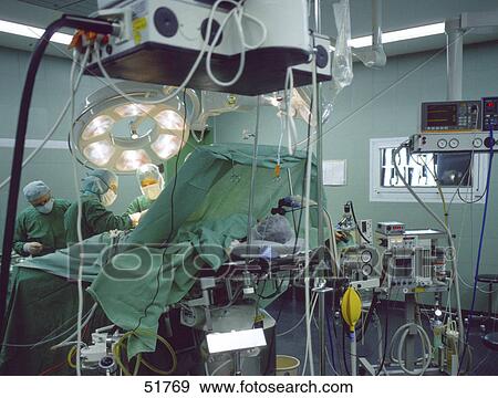 Surgeons operating on patient View Large Photo Image Stock Photo - Surgeons operating on patient . Fotosearch