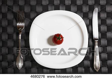 Tomato on white plate View Large Photo Image Stock Photograph - Tomato on white plate . Fotosearch