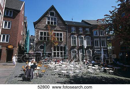 Stock Image - Tourists at outdoor cafe, Aachen, Germany . Fotosearch