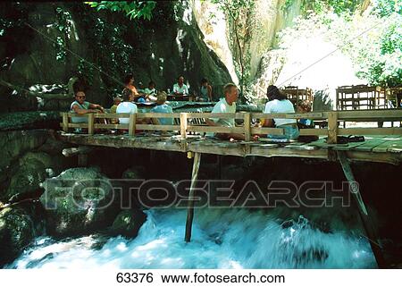 Stock Photograph - Tourists enjoying on bridge across river, Mugla, Turkey . Fotosearch