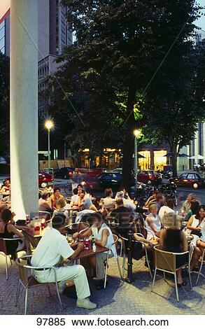 Tourists sitting at roadside cafe, Potsdamer Platz, Berlin, Germany View Large Photo Image Stock Photography - Tourists sitting at roadside cafe, Potsdamer Platz, Berlin, Germany . Fotosearch