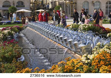 Tourists standing near watering cans in row, Place Stanislas, Nancy, Meurthe et Moselle, France View Large Photo Image Stock Photograph - Tourists standing near watering cans in row, Place Stanislas, Nancy, Meurthe et Moselle, France . Fotosearch