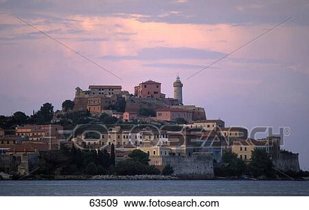 Town on hill against dusky sky, Isle Of Elba, Italy View Large Photo Image Stock Photo - Town on hill against dusky sky, Isle Of Elba, Italy . Fotosearch