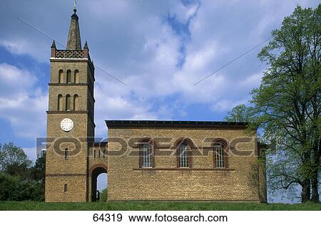 Tree near church, Schinkel Church, Brandenburg, Germany View Large Photo Image Stock Photo - Tree near church, Schinkel Church, Brandenburg, Germany . Fotosearch