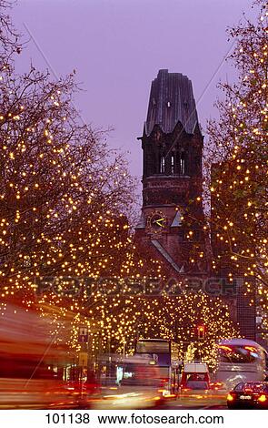 Trees lit up with Christmas lights in front of church, Berlin, Germany View Large Photo Image Stock Photo - Trees lit up with Christmas lights in front of church, Berlin, Germany . Fotosearch