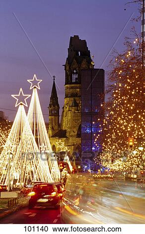 Trees lit up with Christmas lights along road at night, Berlin, Germany View Large Photo Image Stock Image - Trees lit up with Christmas lights along road at night, Berlin, Germany . Fotosearch