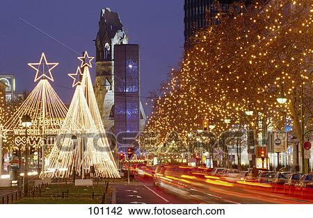 Trees lit up with Christmas lights along road at night, Berlin, Germany View Large Photo Image Stock Image - Trees lit up with Christmas lights along road at night, Berlin, Germany . Fotosearch