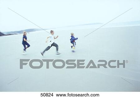 Two boys and girl running on beach View Large Photo Image Picture - Two boys and girl running on beach . Fotosearch
