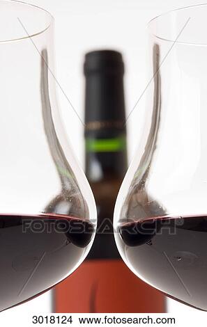Two filled claret glasses in front of wine bottle, cross-section View Large Photo Image Picture - Two filled claret glasses in front of wine bottle, cross-section . Fotosearch