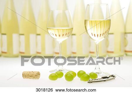Two filled white wine glasses in front of a row of wine bottles, still life View Large Photo Image Stock Photograph - Two filled white wine glasses in front of a row of wine bottles, still life . Fotosearch
