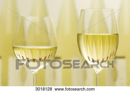 Two filled white wine glasses, upper section View Large Photo Image Stock Photo - Two filled white wine glasses, upper section . Fotosearch