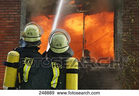 Two firemen extinguishing fire in house View Large Photo Image Stock Photo - Two firemen extinguishing fire in house . Fotosearch