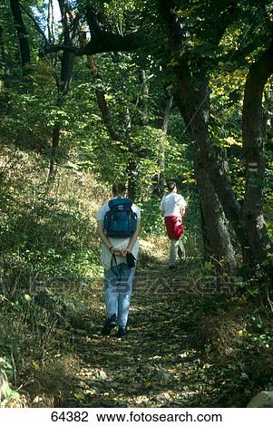 Two mountain hikers in forest, Thuringia, Germany  View Large Photo Image Stock Image - Two mountain hikers in forest, Thuringia, Germany . Fotosearch