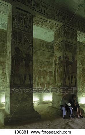 Stock Image - Two people in temple, Great Temple of Ramesses II, Abu SImbel, Aswan, Egypt . Fotosearch