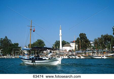 Two people on boat neat harbor, Fethiye, Mugla, Turkey View Large Photo Image Picture - Two people on boat neat harbor, Fethiye, Mugla, Turkey . Fotosearch