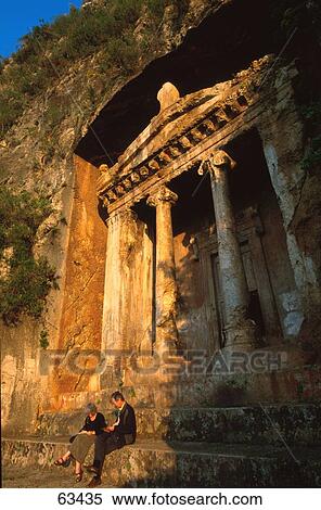 Two people sitting on steps of ancient tomb, Turkey View Large Photo Image Stock Photography - Two people sitting on steps of ancient tomb, Turkey . Fotosearch