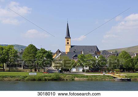 Stock Image - View over Moselle river to church of Trittenheim, Germany . Fotosearch