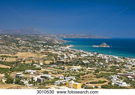 Stock Image - View over the outskirts of Kefalos with Kastri island in the background, Cos, Greece, elevated view . Fotosearch