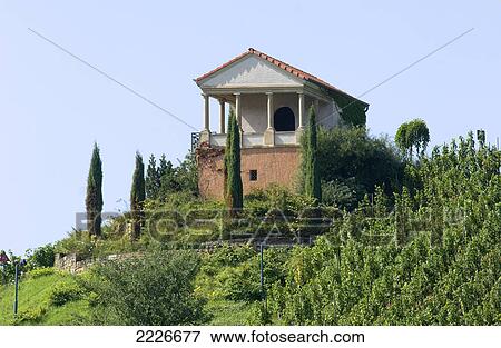 Stock Photo - Vineyard and burial chamber on hill . Fotosearch