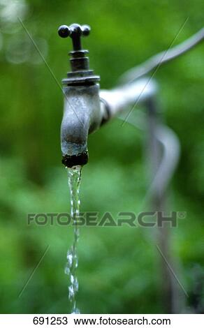 Stock Image - Water pouring out of faucet . Fotosearch