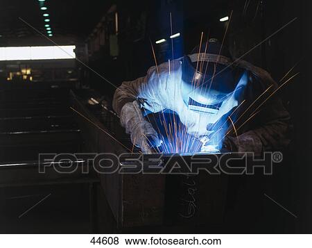 Welder welding metal in workshop View Large Photo Image Stock Photo - Welder welding metal in workshop . Fotosearch
