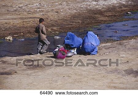 Woman and boy at riverside, Kabul, Afghanistan View Large Photo Image Stock Image - Woman and boy at riverside, Kabul, Afghanistan . Fotosearch