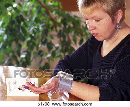Woman checking blood pressure View Large Photo Image Stock Photo - Woman checking blood pressure . Fotosearch