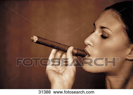 Stock Photo - Woman smoking cigar, side view . Fotosearch