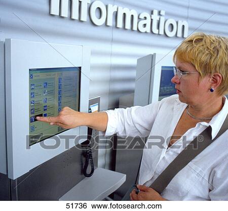 Woman using touch screen information machine View Large Photo Image Stock Photograph - Woman using touch screen information machine . Fotosearch