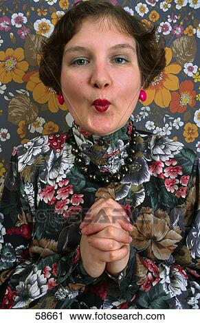 Stock Image - Woman wearing blouse with flowers, portrait . Fotosearch