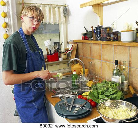 Stock Image - Young man doing dishes . Fotosearch