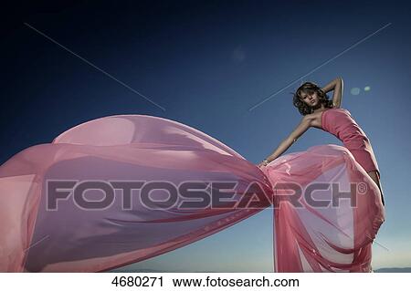 Stock Image - Young woman in pink dress . Fotosearch