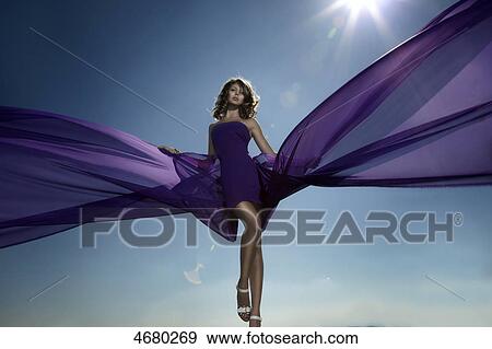Stock Photo - Young woman in purple dress . Fotosearch