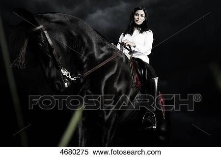 Young woman riding on a horse View Large Photo Image Stock Photography - Young woman riding on a horse . Fotosearch