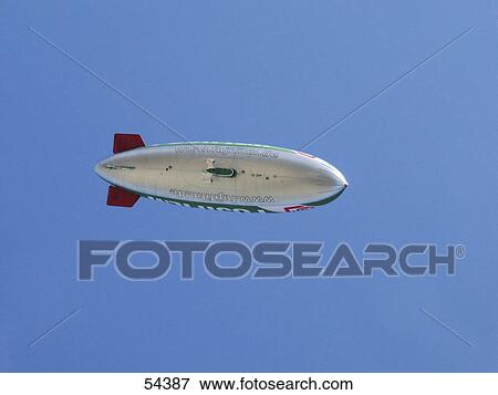 Zeppelin against blue sky View Large Photo Image Stock Photo - Zeppelin against blue sky . Fotosearch