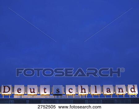 Stock Photography - Advertising board lit up at dusk, Berlin, Germany . Fotosearch