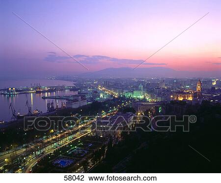Aerial view of a city lit up at dusk View Large Photo Image Stock Image - Aerial view of a city lit up at dusk . Fotosearch