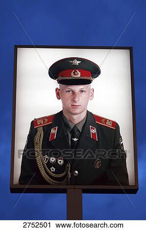 Stock Image - Billboard displaying solders picture against dusky sky, Berlin, Germany . Fotosearch